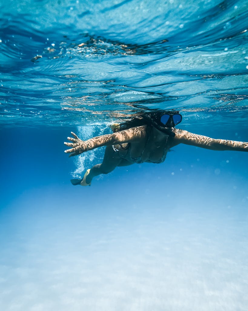 Woman snorkeling in clear blue waters near Honolulu, Hawaii.